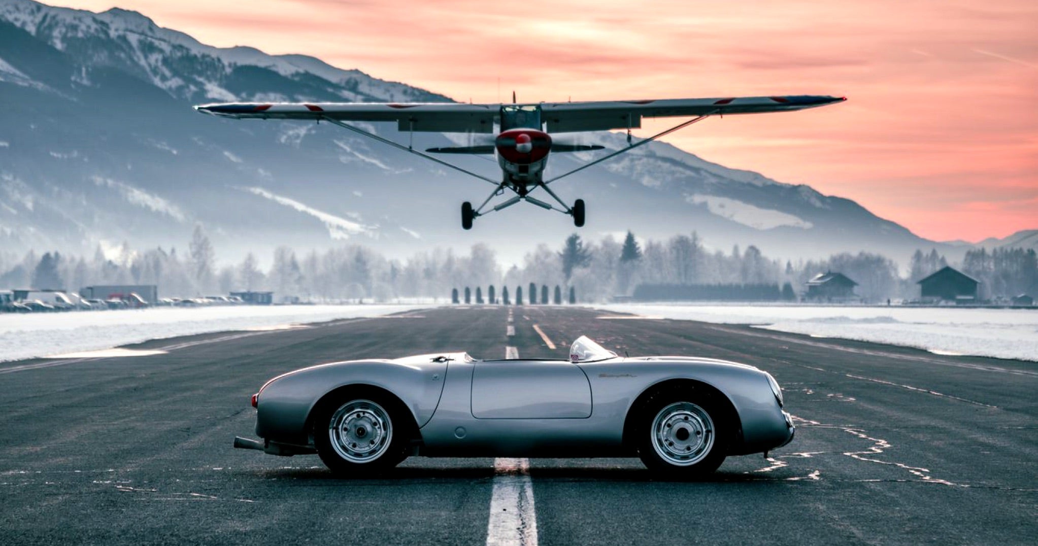 <span>A propeller plane flies overhead a vintage 550 Spyder to commemorate 2021’s “Cold Start by GP,” a virtual iteration of the Ice Race due to the coronavirus pandemic</span> <br/><span class="caption-sub"><em>Photo credit: Max Zappolino</em></span>